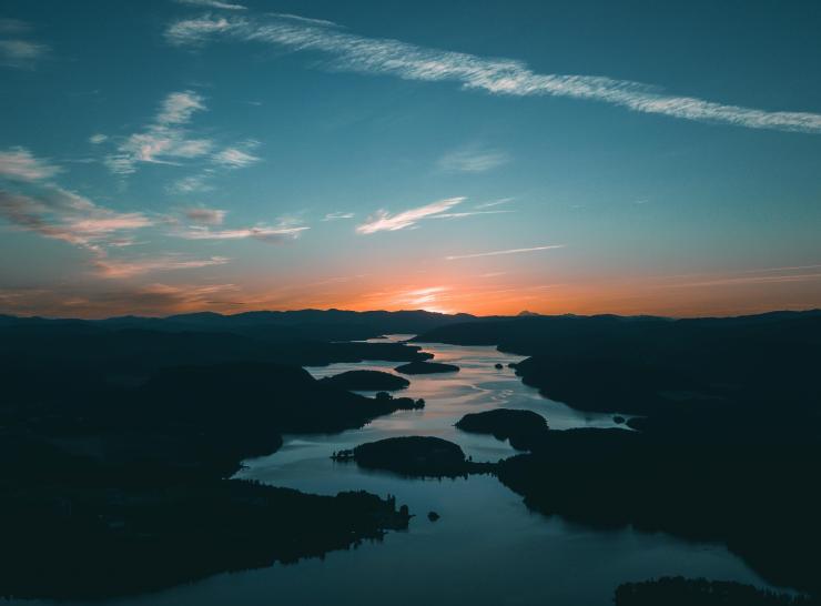 Image of the sun setting over a body of water